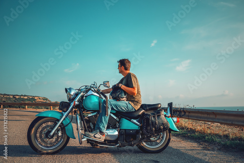 Biker on a classic motorcycle by the sea