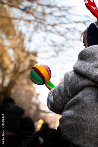 Α baby with a rattle in Carnival