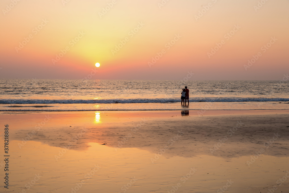 Idyllic pink scene of landscape with Pair  together, Indian Ocean and sunset