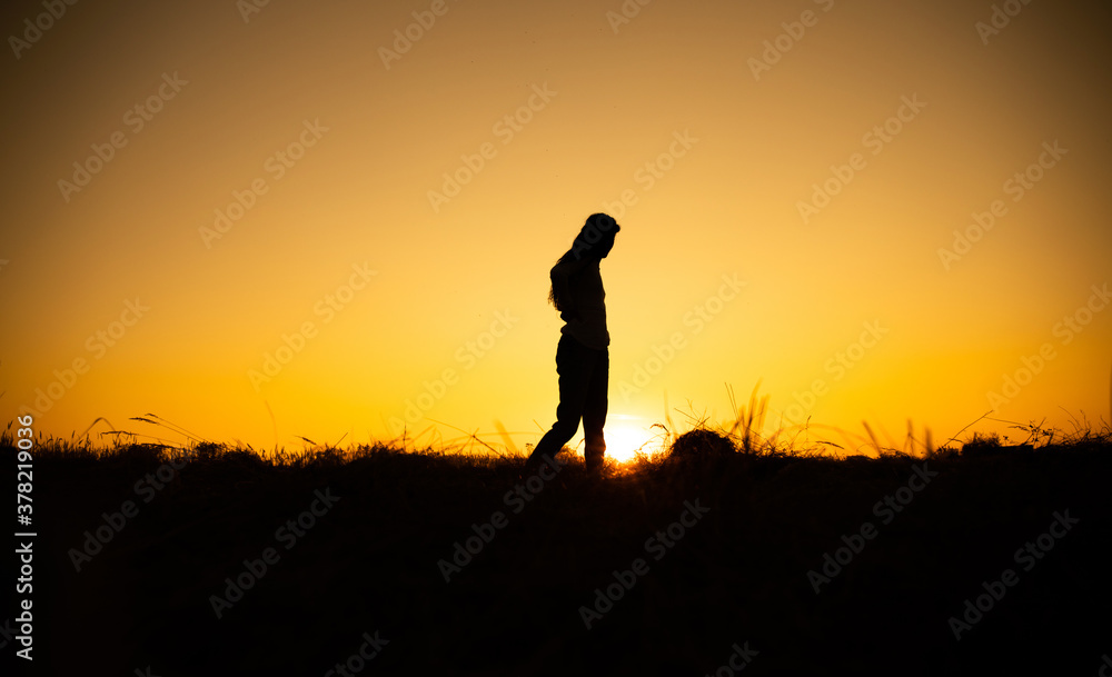 Silhouette of woman posing at sunset
