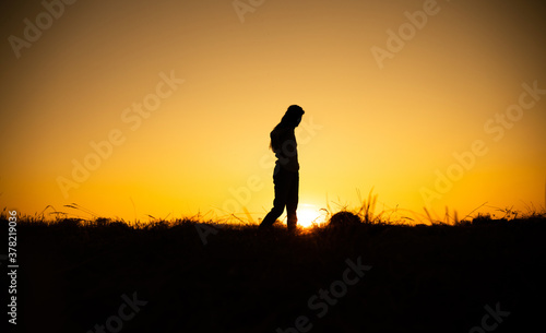 Silhouette of woman posing at sunset  © Erika