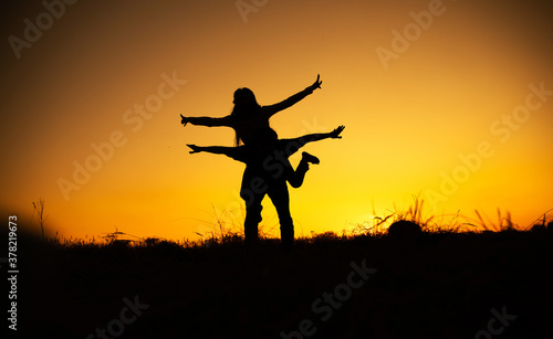 silhouettes in love romantic couple lovers hugging. Couple in love. Sensual. Happy day. Sunset. Photo. Background. 