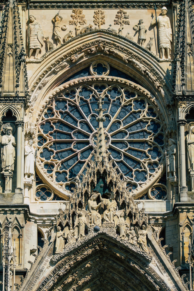 Naklejka premium View of the exterior facade of the Roman Catholic Notre Dame de Reims Cathedral, a historical monument in the Grand Est region of France and one of the oldest in Europe
