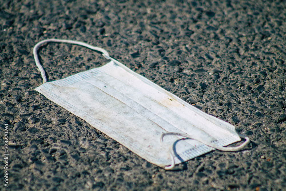 View of a surgical mask to protect against the coronavirus thrown in the streets of Reims, a city in the Grand Est region of France View of a surgical mask to protect against the coronavirus thrown in the streets of Reims, a city in the Grand Est region of France