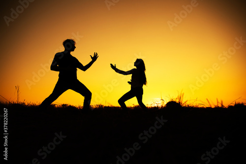 Fighting Silhouette. Silhouette people in front of sunset. Shadow. 
