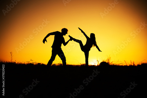 Aggression and abuse concept. Man and woman expressing domestic violence. Sunset. 