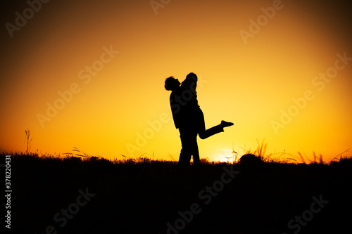 silhouettes in love romantic couple lovers hugging. Couple in love. Sunset. Beauty photo. Sensual. 