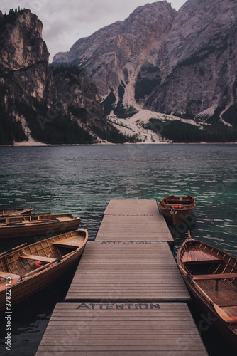 Amazing view of Lago di Braies, Pragser wildsee. Trentino Alto Adidge, Dolomites mountains, South Tyrol, Italy, Europe. Boats at the lake. Fanes-Sennes-Braies national park. brown boats