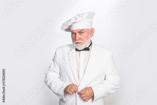 Chef in uniform. Kitchen. Cooking. Male chef in white uniform. Serious bearded chef, cook or baker. Cook.