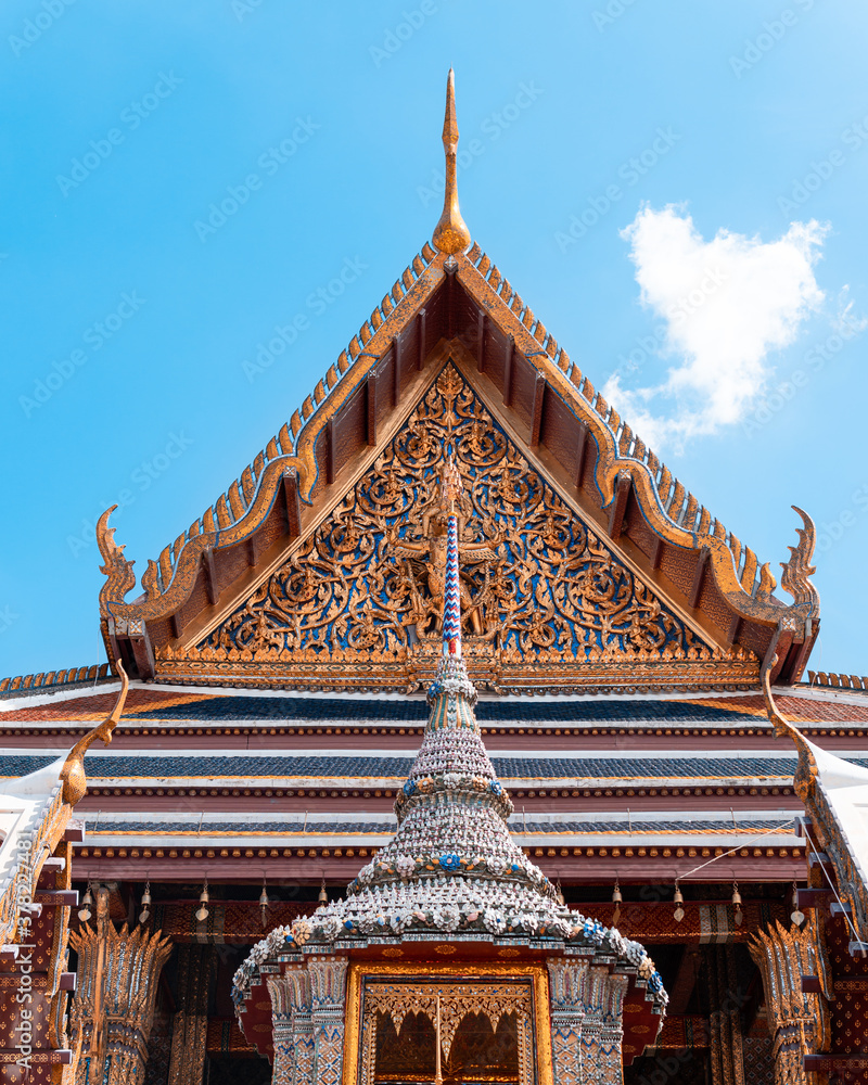 Amazing Art at Top of a Temple's Entrance in Bangkok, Thailand in a Perfect Blue Skies Day.