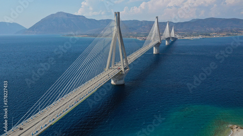 Aerial drone photo of world famous cable suspension bridge of Rio - Antirio Harilaos Trikoupis, crossing Corinthian Gulf, mainland Greece to Peloponnese, Patras