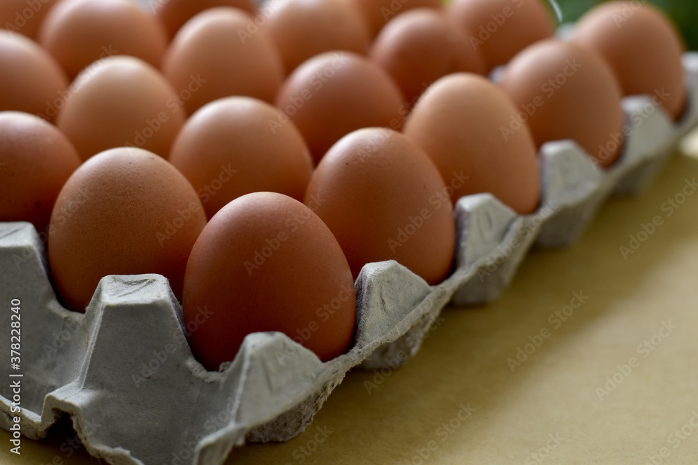 Close up Raw Brown Chicken Eggs, Easter eggs In Paper Container, selective focus points. Close up Raw Brown Chicken Eggs, Easter eggs In Paper Container, selective focus points.