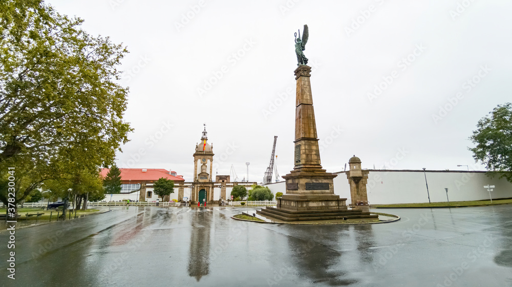 Roundabout of the city of Ferrol with Obelisk Monument and Dock Gate in the shipyards, a rainy day