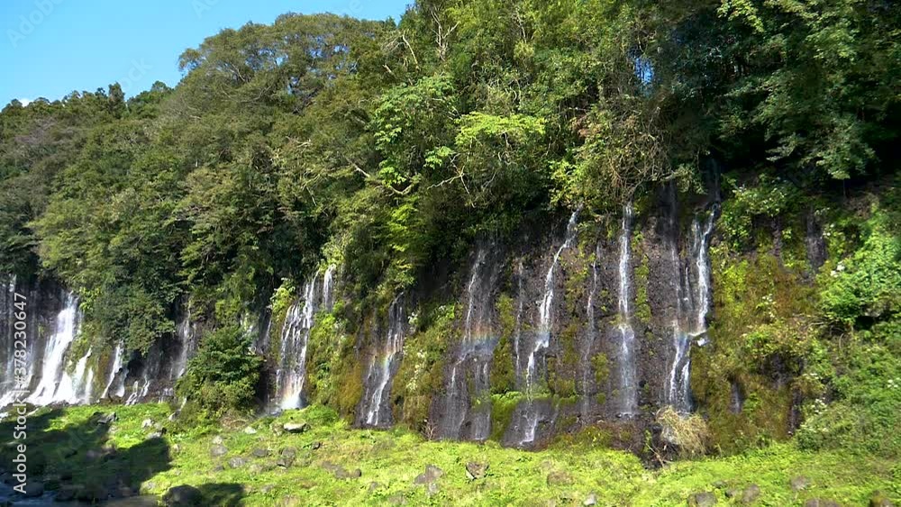 Small waterfalls falling from the mountains in Shiraito falls in Japan Small waterfalls falling from the mountains in Shiraito falls in Japan