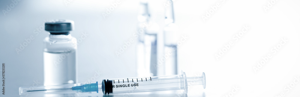 Medical syringe with a needle and a bollte with vaccine. Medical syringe with a needle and a bollte with vaccine.
