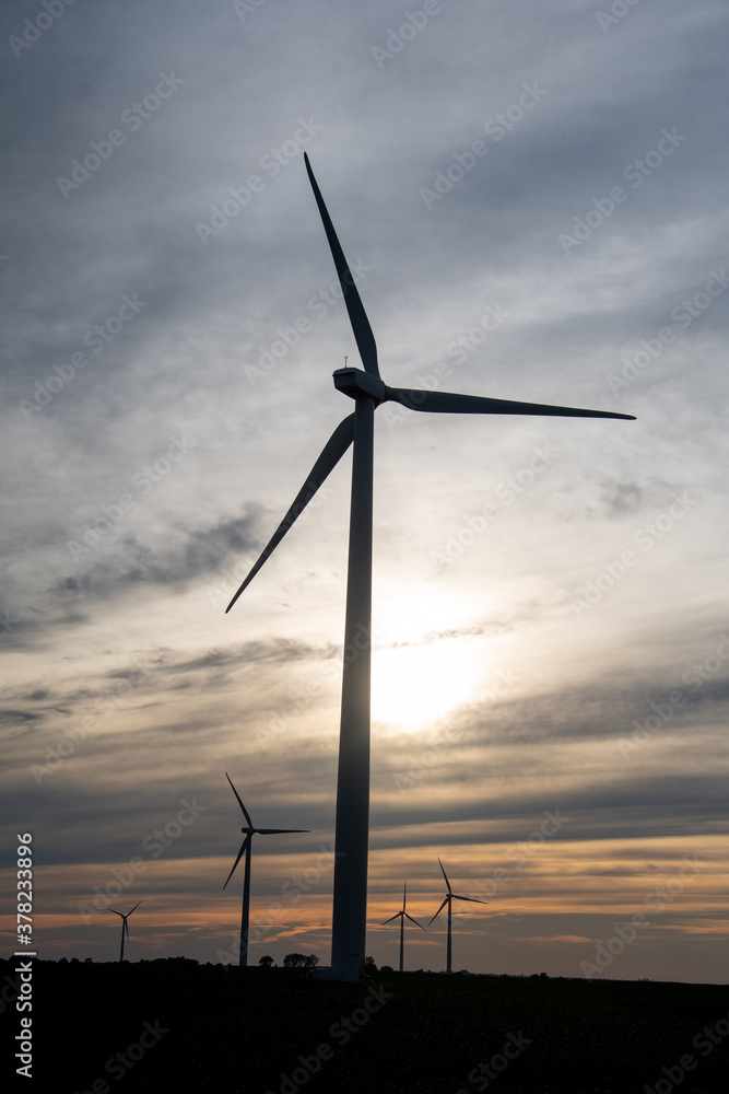 Sunset behind a field of wind turbines Sunset behind a field of wind turbines