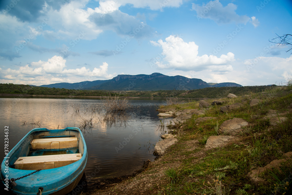 boats on the lake with blue sky and mountains 