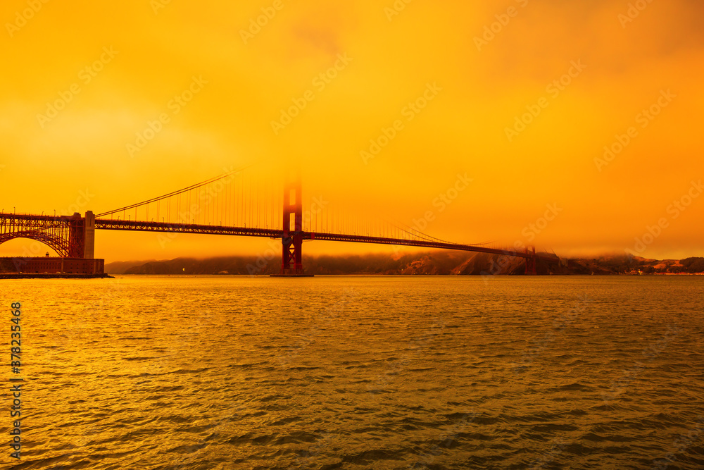 Wildfires smoky orange sky on Golden Gate bridge of San Francisco skyline from Fort point. Californian fires in United States of America. Composition about wildfires and climate change concept. Wildfires smoky orange sky on Golden Gate bridge of San Francisco skyline from Fort point. Californian fires in United States of America. Composition about wildfires and climate change concept.