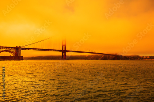 Wildfires smoky orange sky on Golden Gate bridge of San Francisco skyline from Fort point. Californian fires in United States of America. Composition about wildfires and climate change concept.