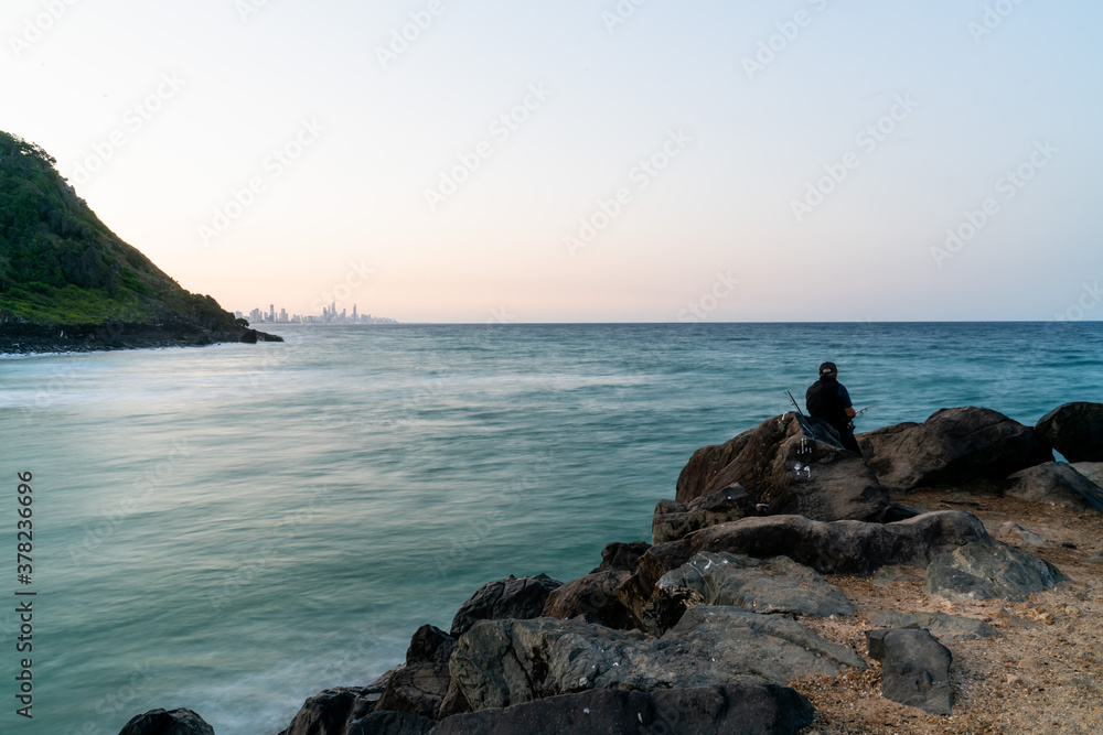 Slow exposure of the Palm beach groyne with fisherman in the foreground