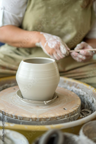 Woman making pottery on the wheel © sashapritchard