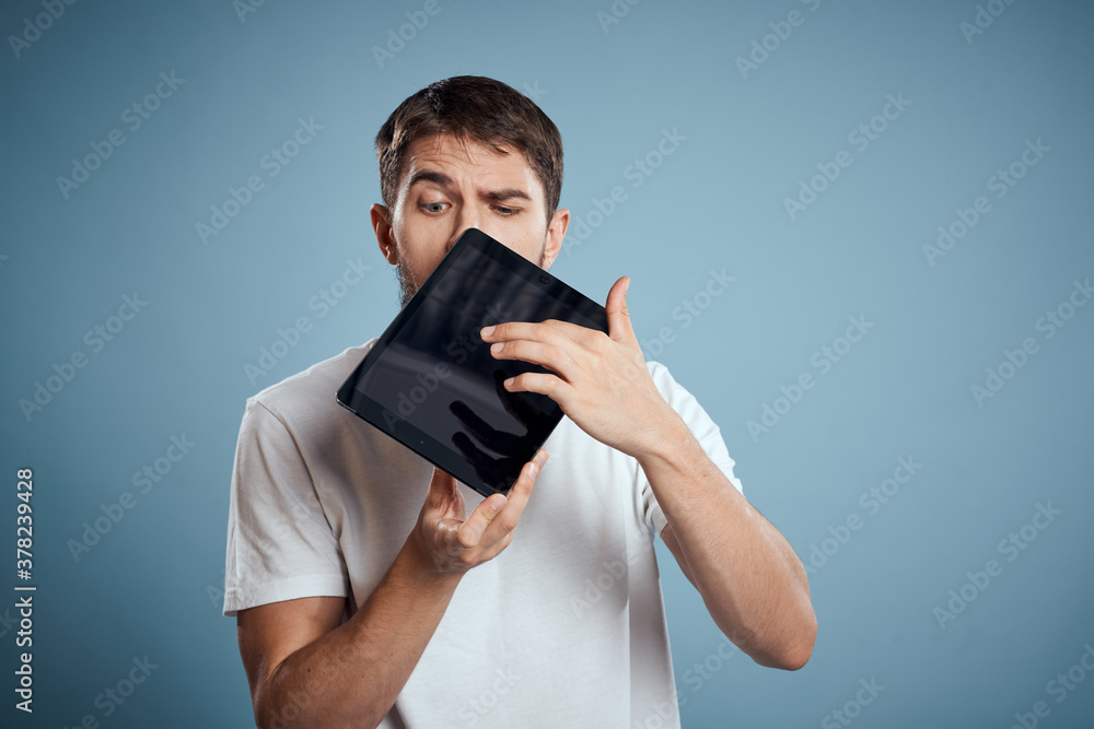 man with touch tablet in hands on blue background gesturing with hands cropped view copy space emotions model man with touch tablet in hands on blue background gesturing with hands cropped view copy space emotions model