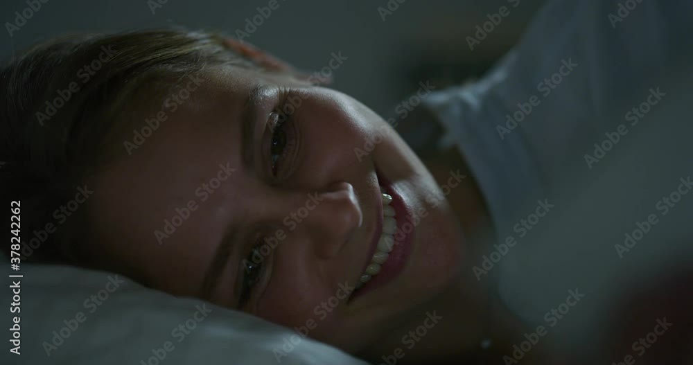 Authentic shot of an young blond woman is using a smartphone or tablet before fall asleep in a cosy bed in a bedroom at night.Concept of technology,connection, internet,network, relax Authentic shot of an young blond woman is using a smartphone or tablet before fall asleep in a cosy bed in a bedroom at night.Concept of technology,connection, internet,network, relax