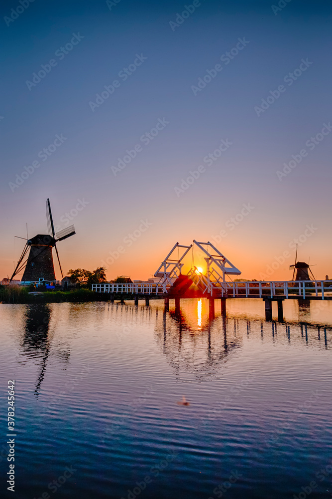 Traditional Romantic Dutch Windmills in Kinderdijk Village in the Netherlands During Golden Hour.