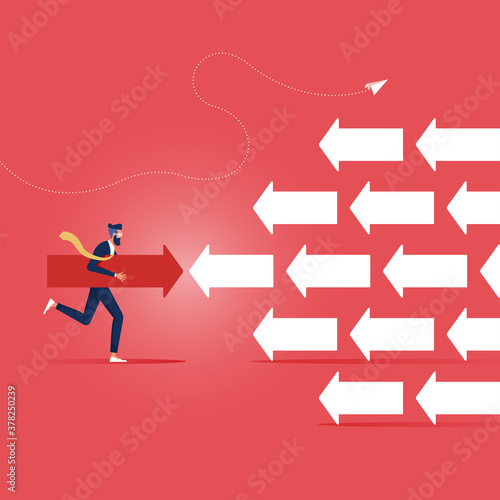 Business strategy concept-Businessman pushing arrow in opposite direction, Opposite Direction, Standing Out From The Crowd, Opponent, Against Obstacles