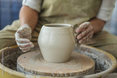 Woman making pottery on the wheel