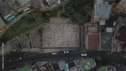 Top Down Aerial View of Basketball Court in Comuna Trece Slum, Medellin Colombia photo