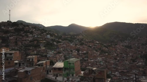 Aerial View of Sunset Above Hillside Slum Favela Buildings in Medellin Colombia. Once Dangerous Neighborhood and Drug Cartel Residence photo