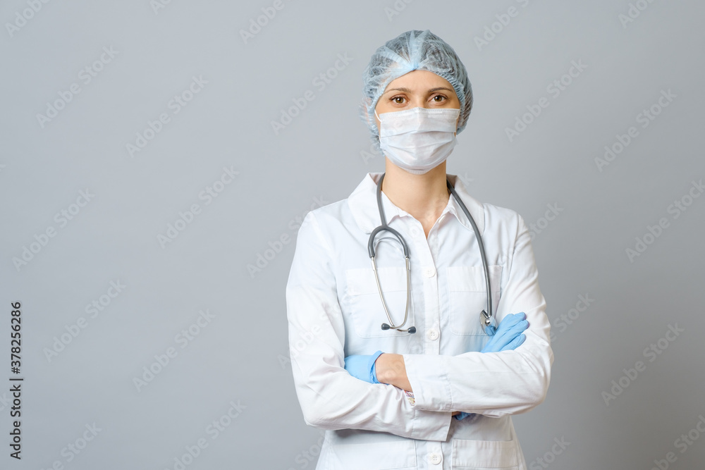 Portrait female doctor in protective medical mask and cap Portrait female doctor in protective medical mask and cap