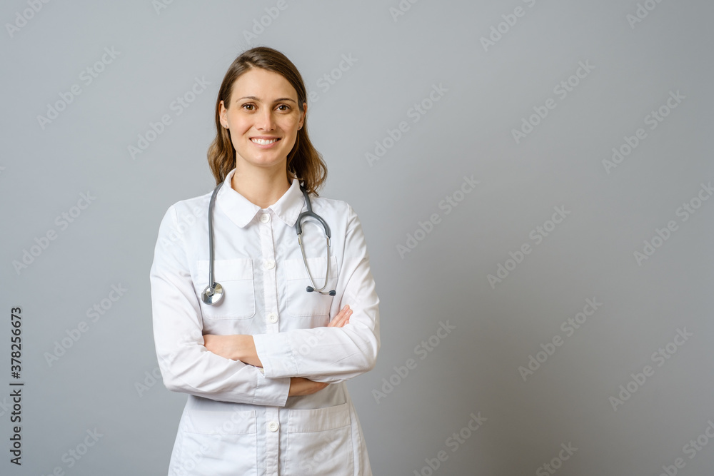 Smiling female doctor in lab coat with arms crossed Smiling female doctor in lab coat with arms crossed