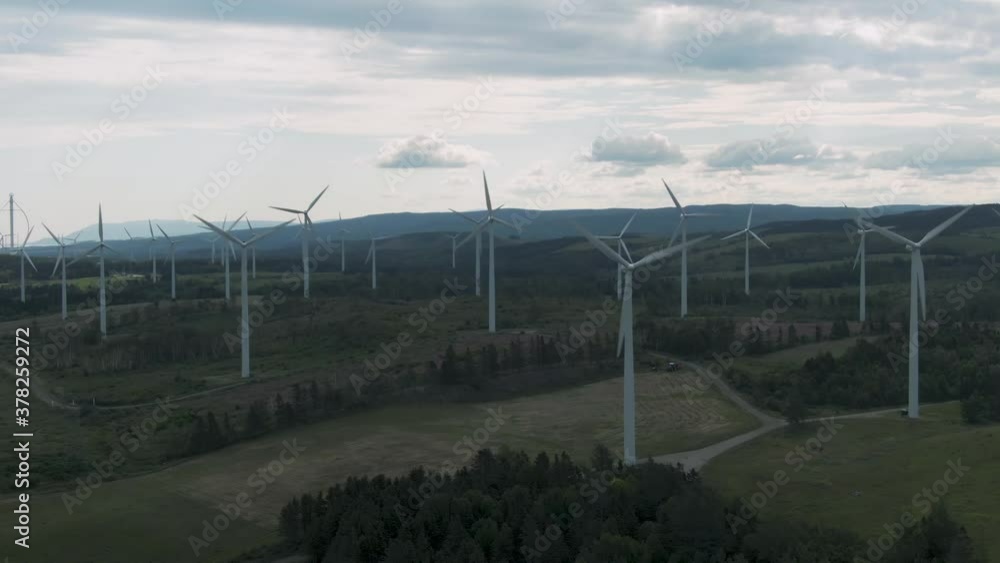 Wind Turbines On A Cloudy Meadow Landscape In Saint Lawrence, Quebec Canada. - Aerial Arch Shot Wind Turbines On A Cloudy Meadow Landscape In Saint Lawrence, Quebec Canada. - Aerial Arch Shot