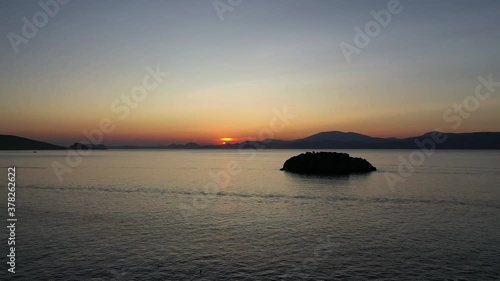 A small island in front of Vlychos Plakes Beach in Hydra Island, Greece photo