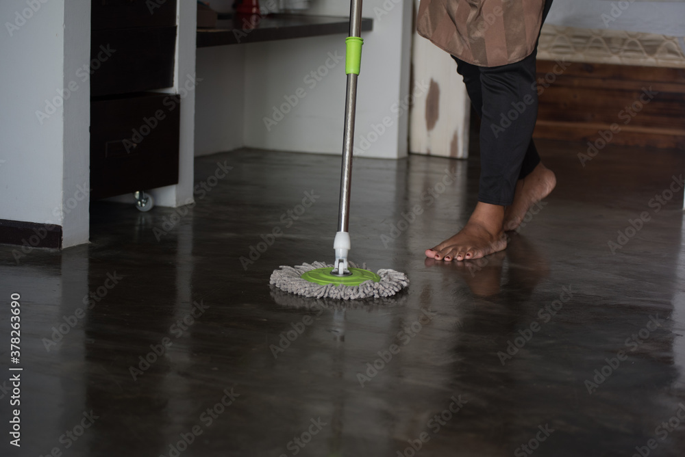Fototapeta premium person cleaning floor with mop