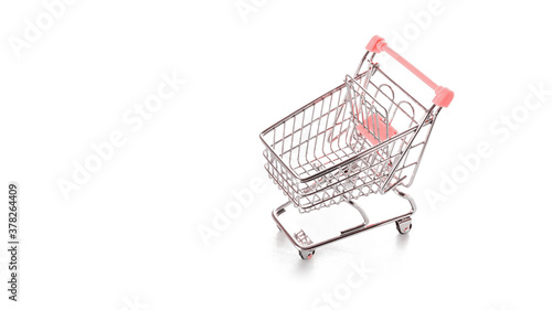 Sale banner. Food shopping basket for retail market. Empty trolley cart for supermarket isolated on white background. Sale, discount, shopaholism concept. Consumer society trend.