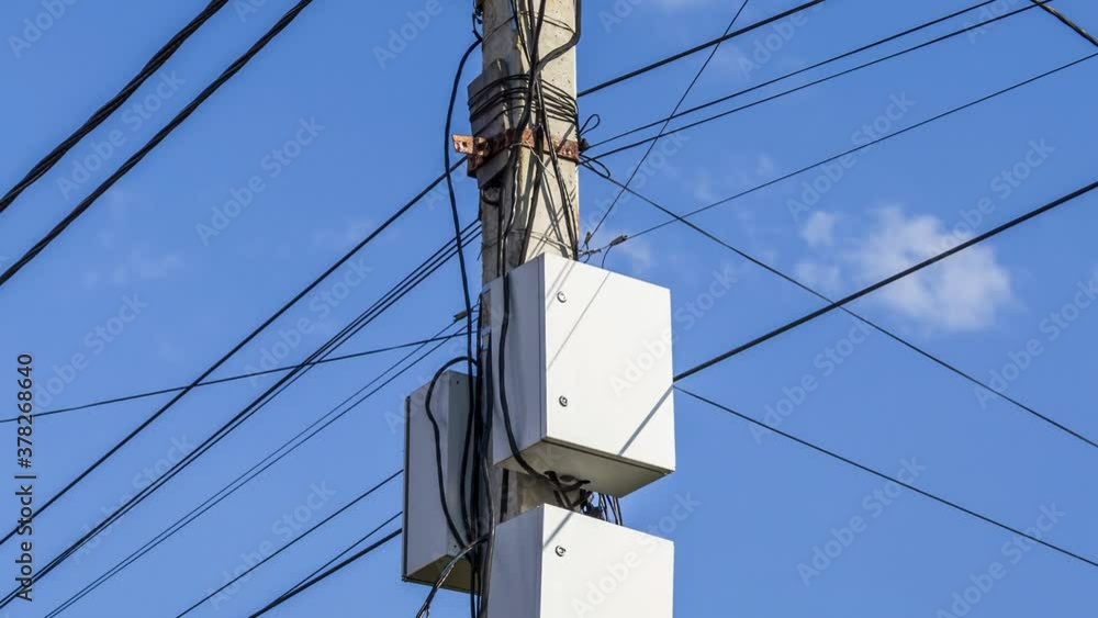 Electrical wires and boxes with electrical equipment on a concrete pole. Electrical wires and boxes with electrical equipment on a concrete pole.