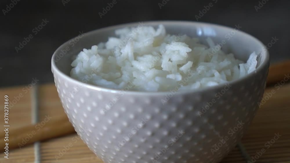 Rice in a porcelain bowl, with Japanese chopsticks, soy sauce, served on a gray stone table Close up Rotation Video hd Rice in a porcelain bowl, with Japanese chopsticks, soy sauce, served on a gray stone table Close up Rotation Video hd