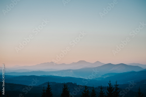 Silhouette of mountains, blue foggy mountains with mist and fog.
