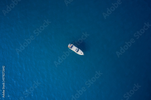 Yacht at the sea in Europe. Top view from drone of yacht. Large white yacht on calm blue water