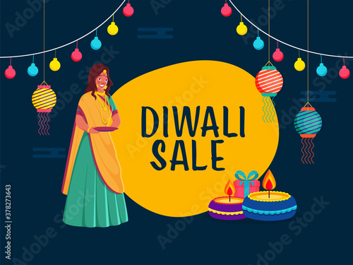 Diwali Sale Poster Design with Indian Young Woman Holding a Empty Plate, Lit Oil Lamps, Gift Box, Hanging Lanterns and Lighting Garland on Blue and Yellow Background.