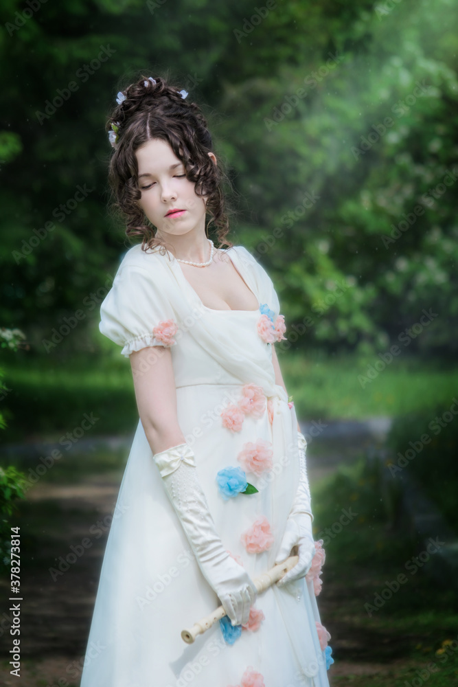 Woman musician with a flute in the garden. Woman musician with a flute in the garden.
