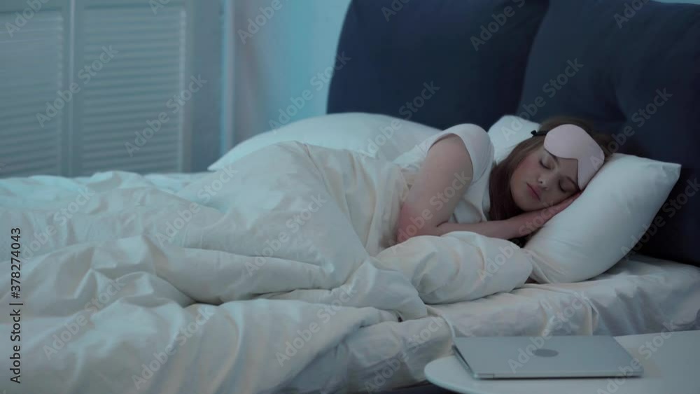 Young woman turning off laptop and going to sleep Young woman turning off laptop and going to sleep