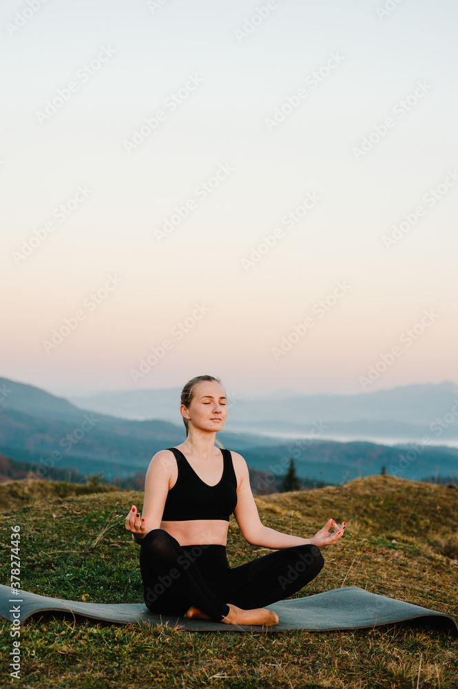 Woman practicing meditate and zen energy yoga in mountains. Healthy lifestyle concept. Young girl doing fitness exercise sport outdoors in beautiful landscape. Morning sunrise. Relax in nature.