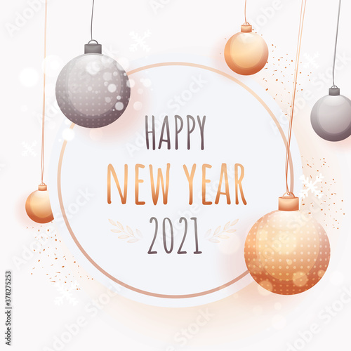 2021 Happy New Year Text on White Background Decorated with Hanging Baubles and Bokeh Effect.