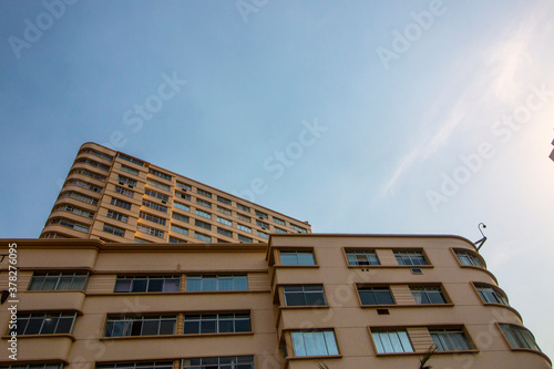 Upward View of Residential Building Against Blue Sky