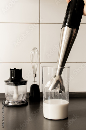 Immersion blender (hand blender) with whisker and chopper (food processor) black and silver in the kitchen, making vegan mayonnaise