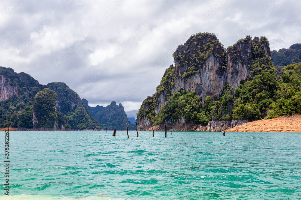 Fototapeta premium Beautiful mountains lake river sky and natural attractions in Ratchaprapha Dam at Khao Sok National Park